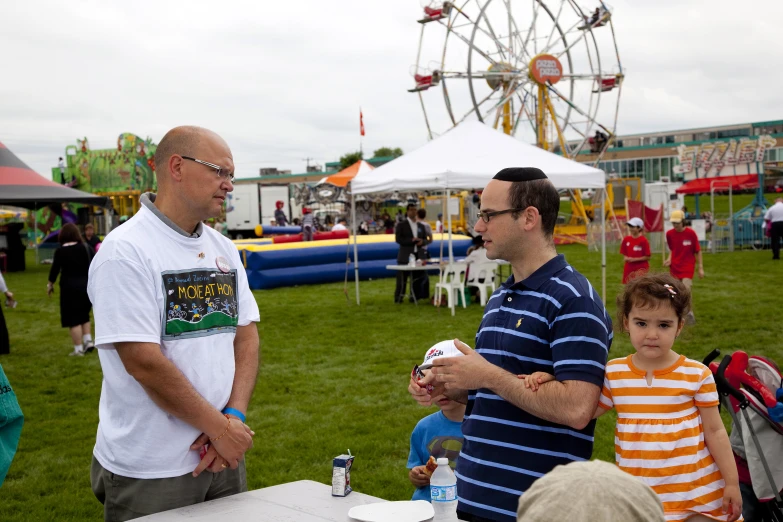 a man stands next to a  at an fair