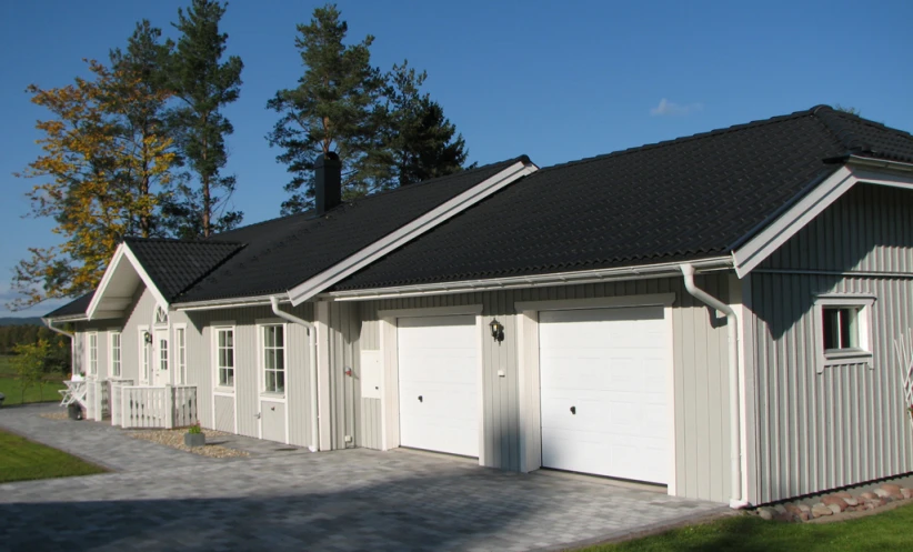 two garages with attached dormers to the roof