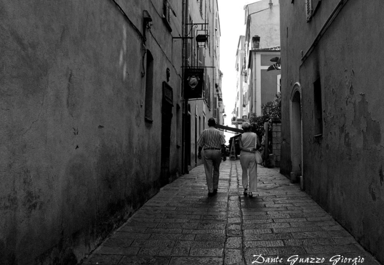 black and white po of two people in a narrow alley