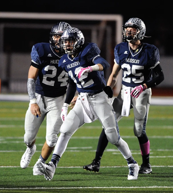 the football players in uniforms are playing on the field