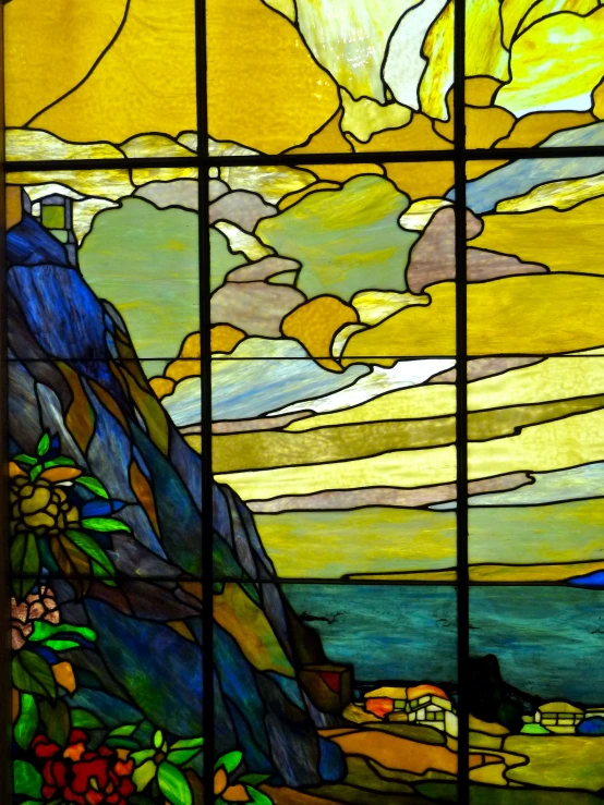 the landscape is depicted with a stain glass window