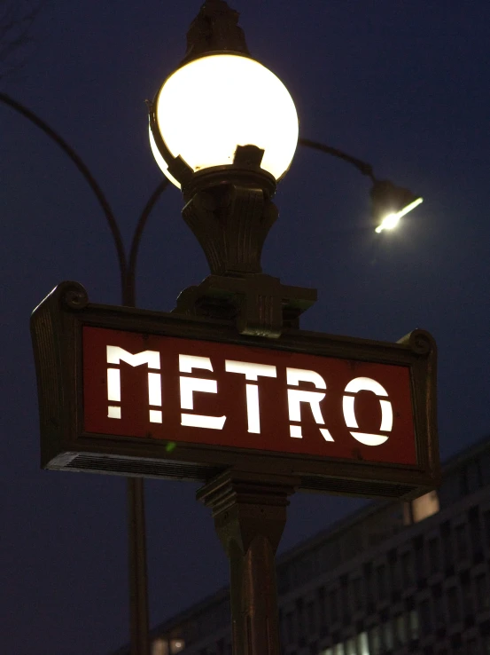 the lighted metro sign shows a street name and location