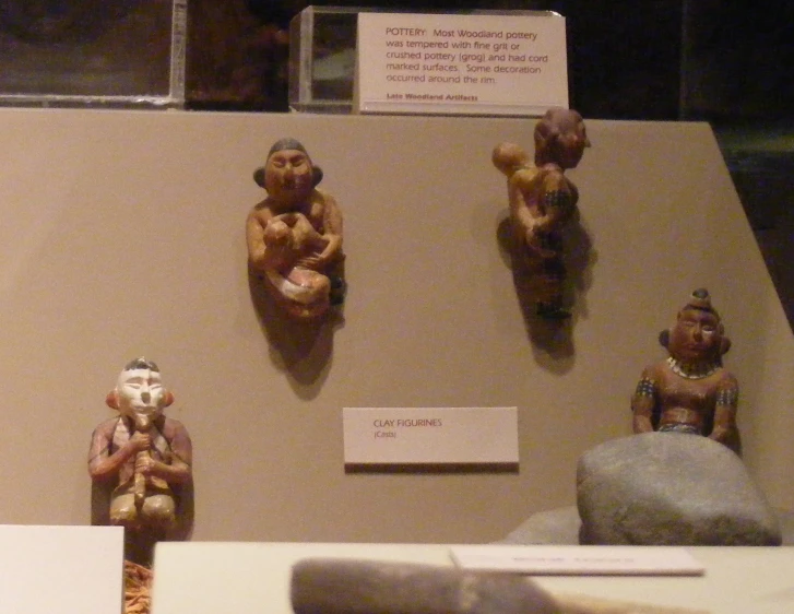 several figurines that look like human bodies and on display