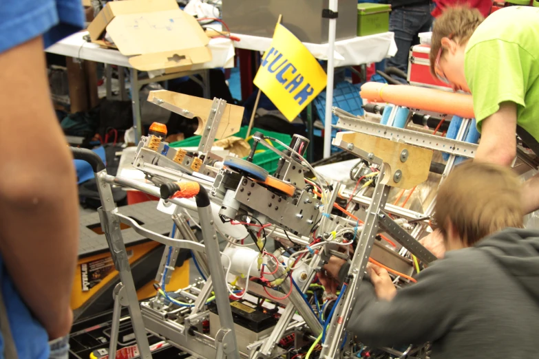 people working with a mechanical project at the table