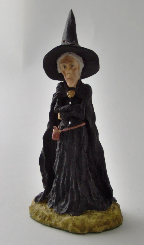 a small wizard figurine standing on a base