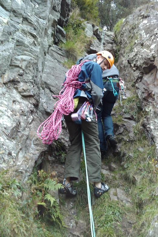 the two men are hiking up a rocky mountain