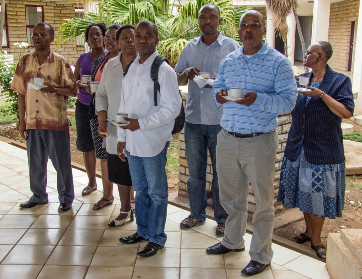 group of people standing around outside, waiting