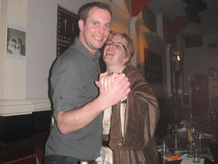 a man and a woman standing together in a room