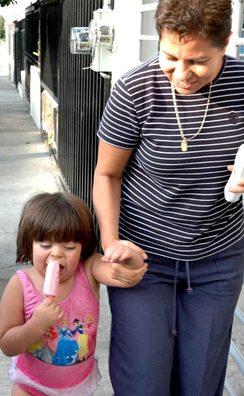 a woman is standing next to a child