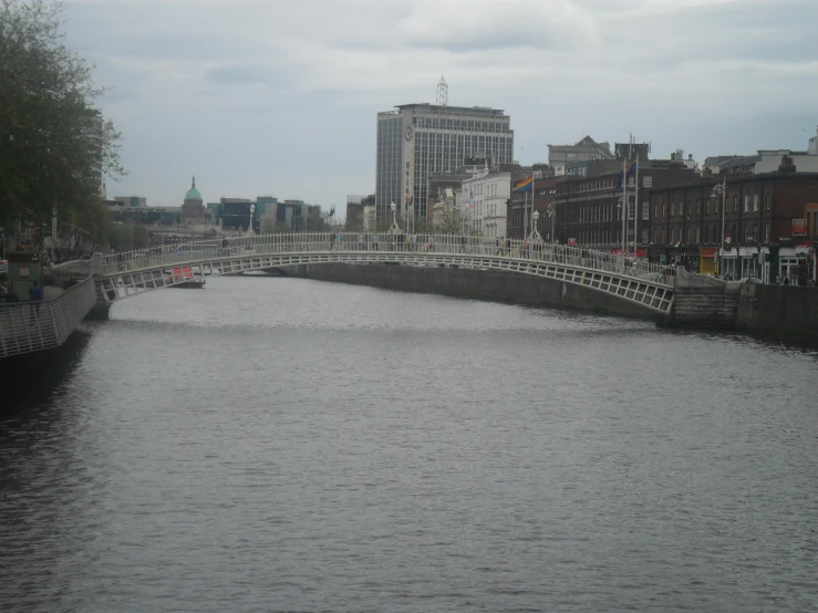 a river flowing through a city next to tall buildings