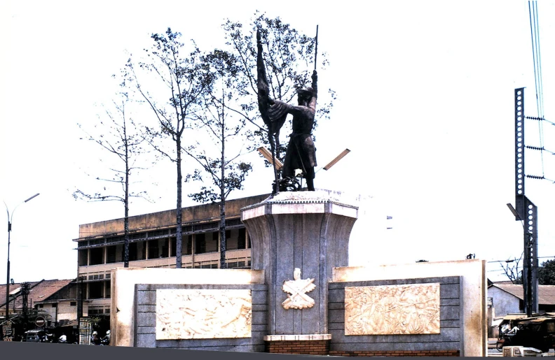 a statue sitting next to a brick wall