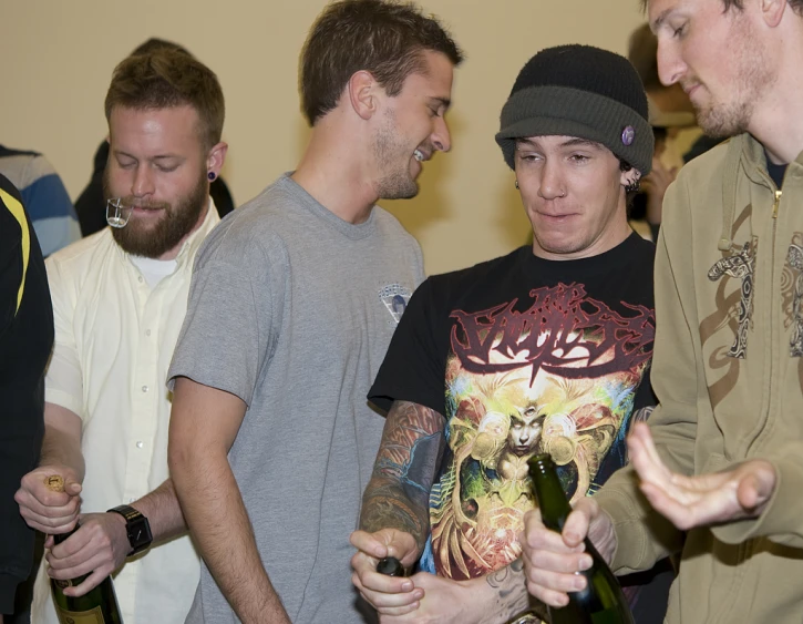 a group of men stand and talk around