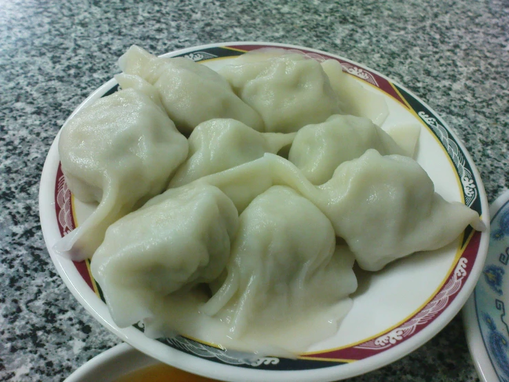 a bowl filled with dumplings on a counter