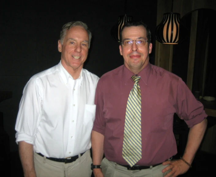 two men standing next to each other while wearing neck ties