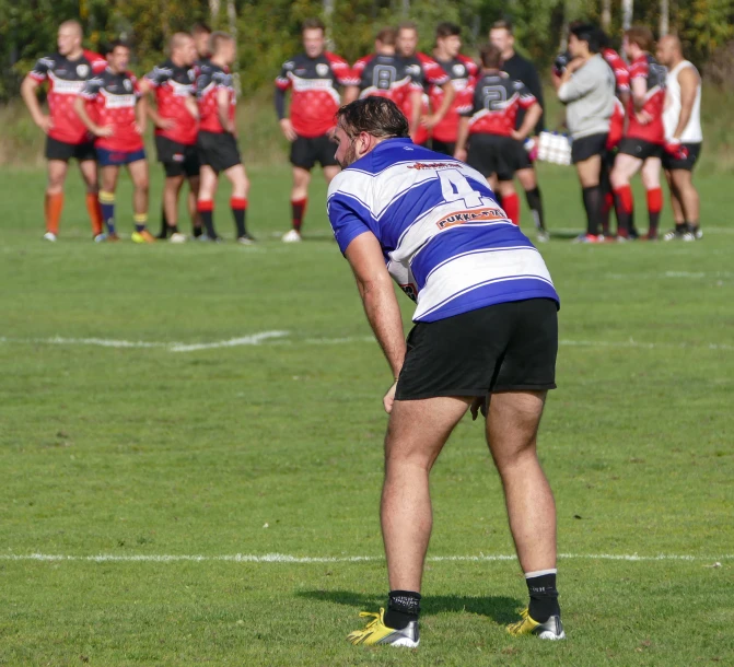 a football team with the referee on the sidelines