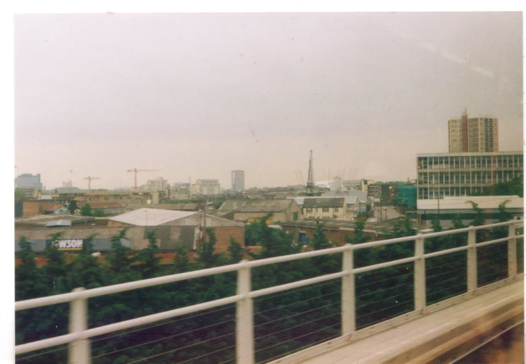 a white train is riding down the tracks in the city