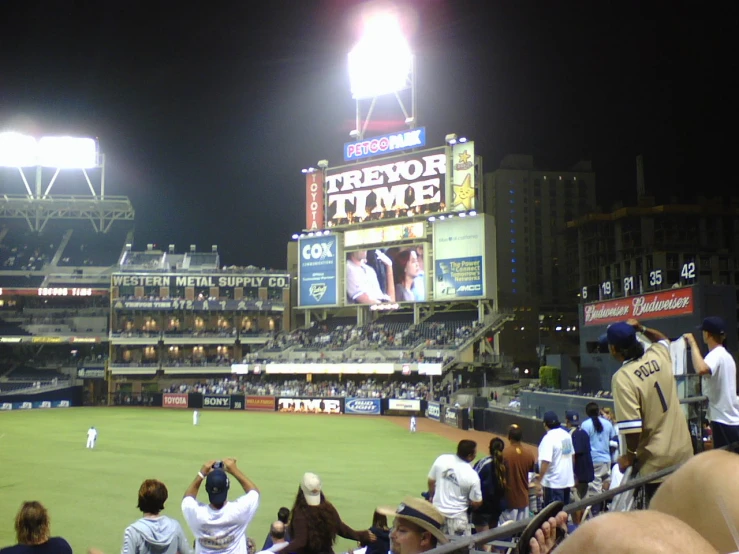 a crowd watches a baseball game in the stadium