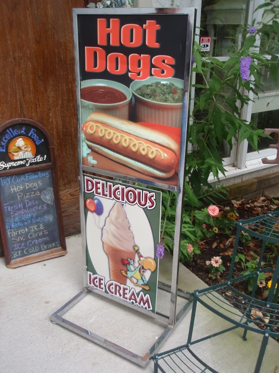 a  dog sign sitting next to a wooden fence