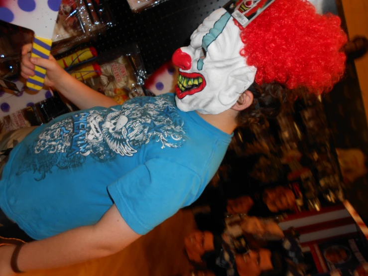 a woman wearing a clown's mask standing at the top of a bar