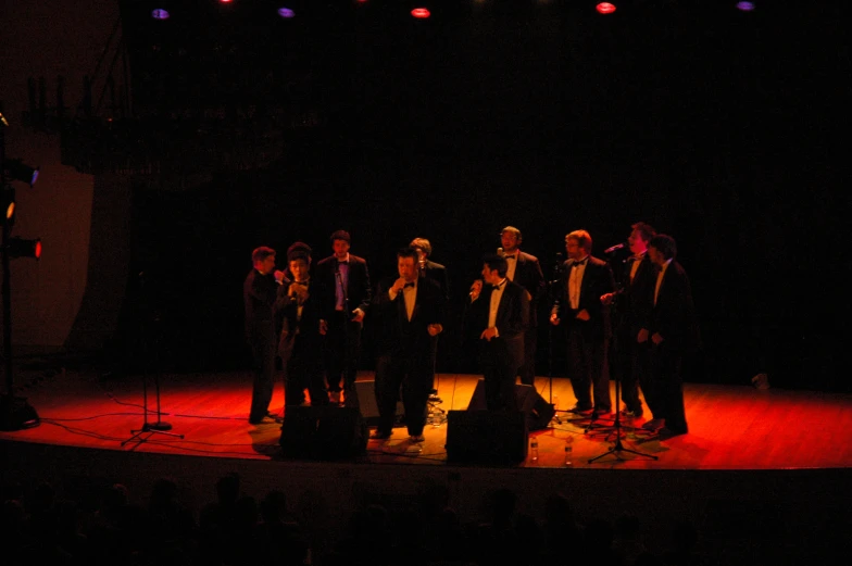 a group of men standing on top of a stage