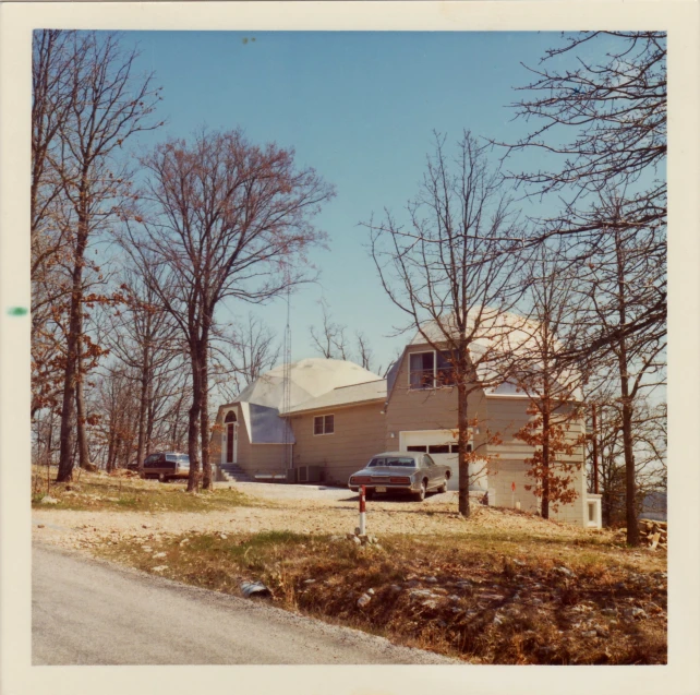 a large white structure sitting in front of trees