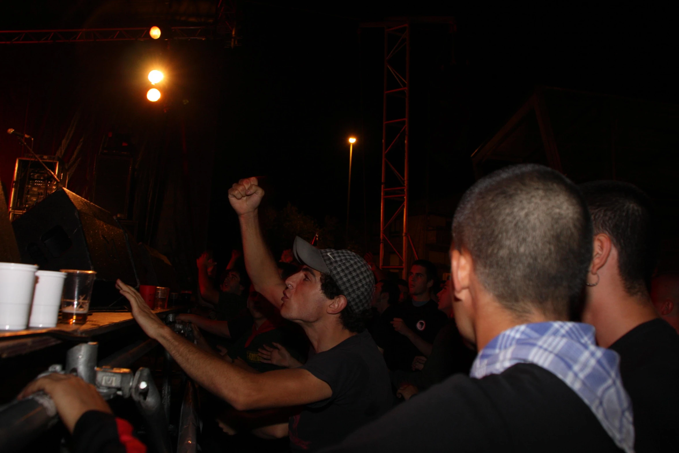 a crowd of people standing around in a dark room