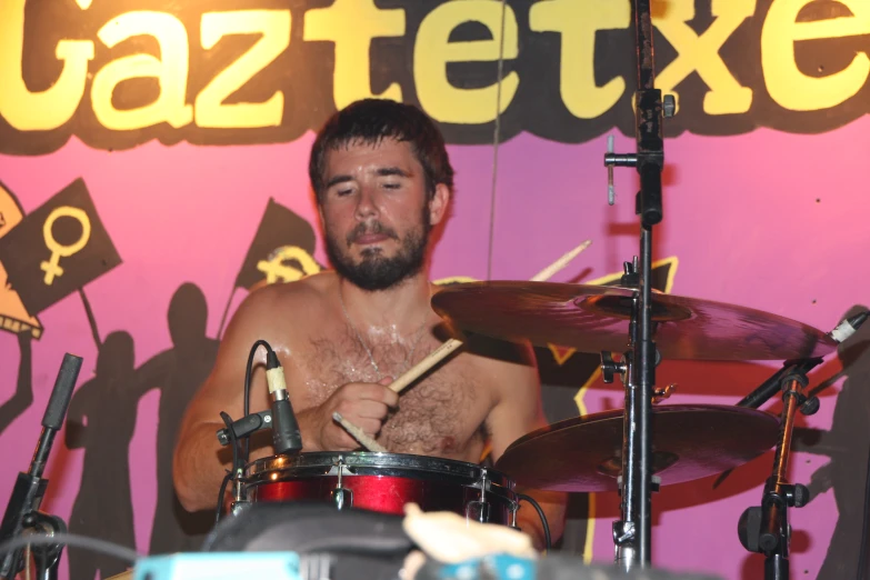 a man is in the picture playing drums