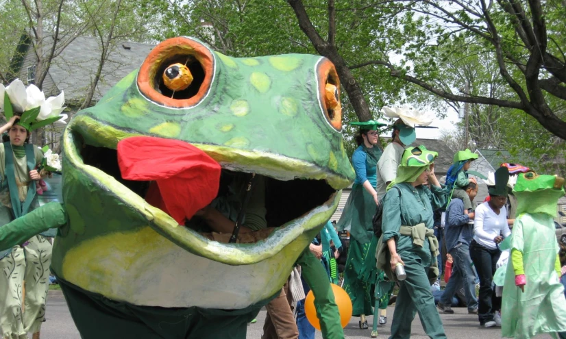 a group of people in costume with hats and holding flowers