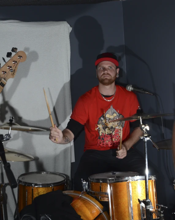 a man sitting in front of drum kit