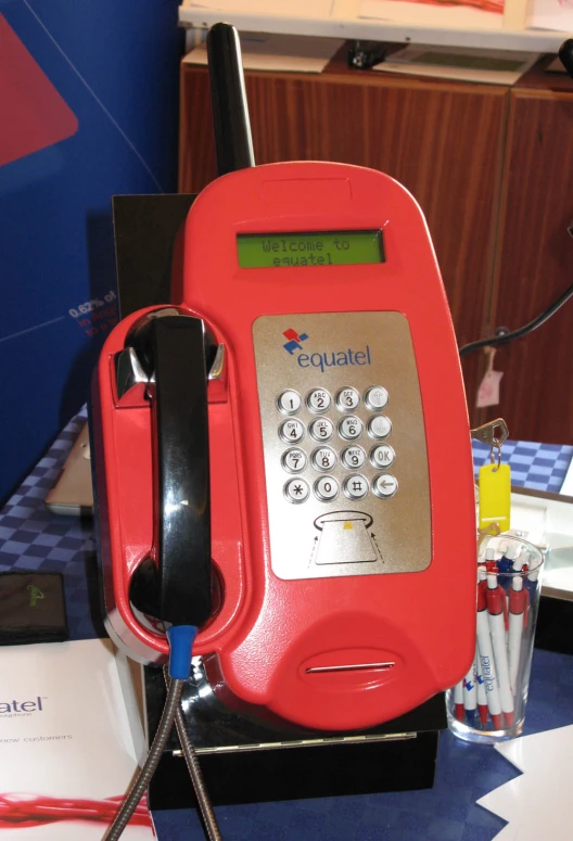 an old style pay phone sitting on top of a stand