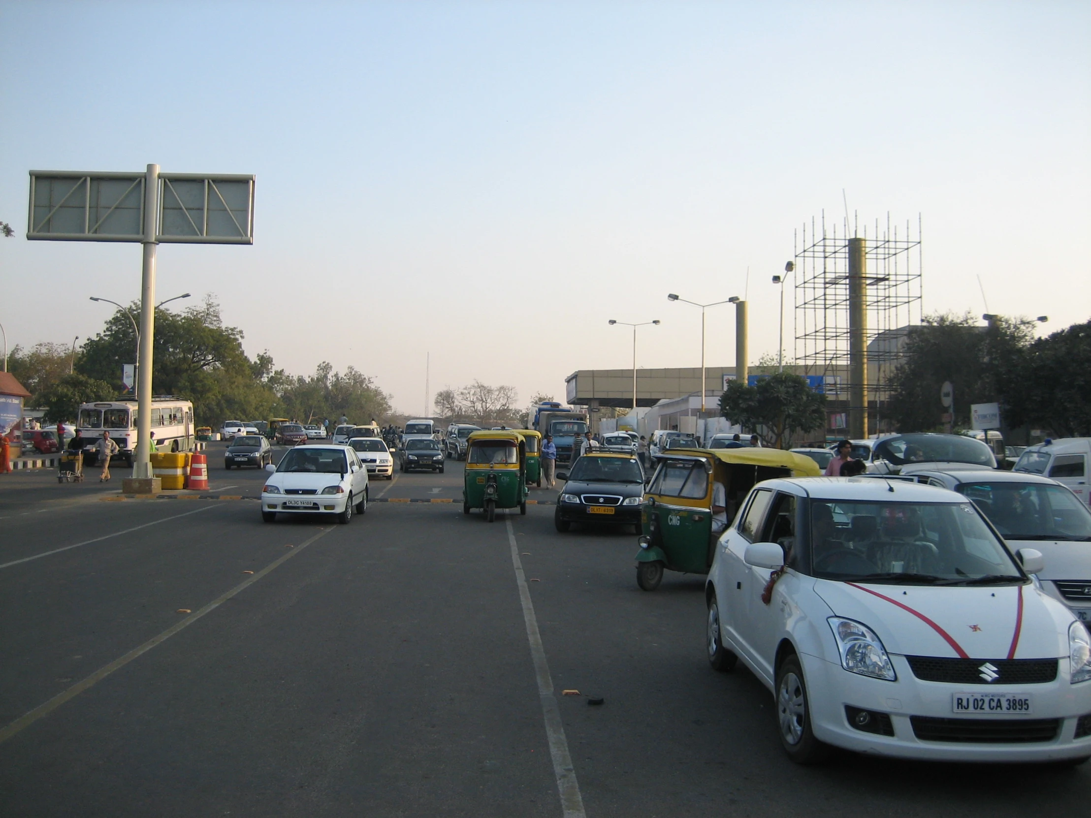 a parking lot with many cars and trucks in it