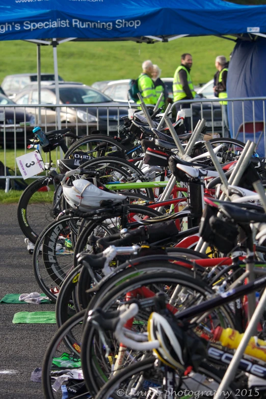 many bikes have been parked under the tent for a race