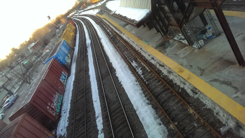 a view looking down at a train track with snow on the tracks