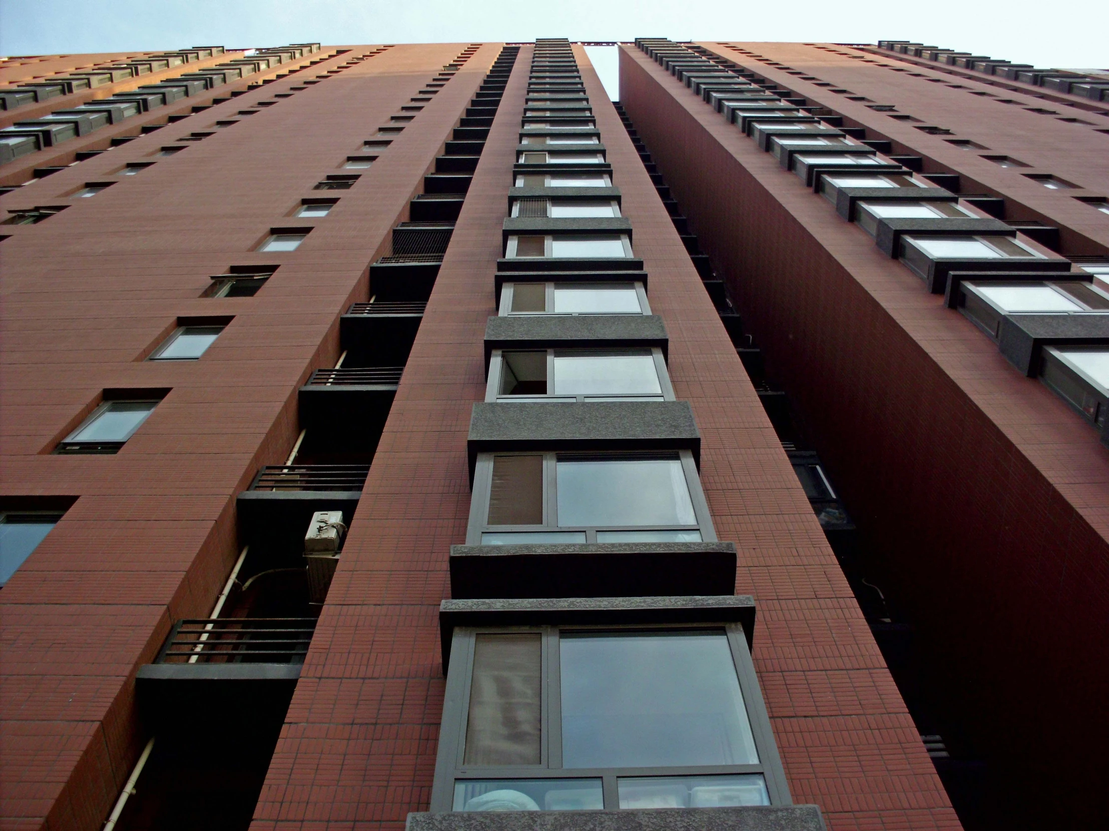 a very tall building with several windows and some balconies