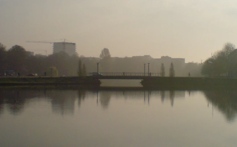 misty morning in a park with reflections in the water