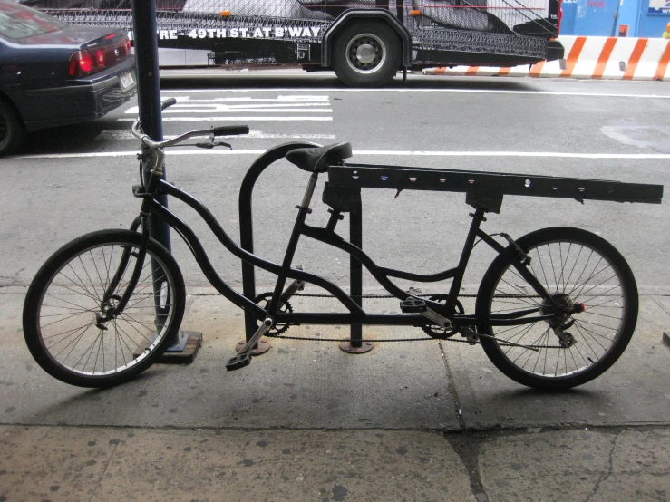 an old bicycle is propped up at the curb