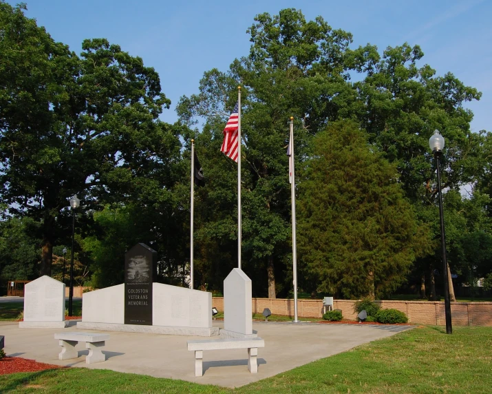 a small war cemetery is shown with a flagpole