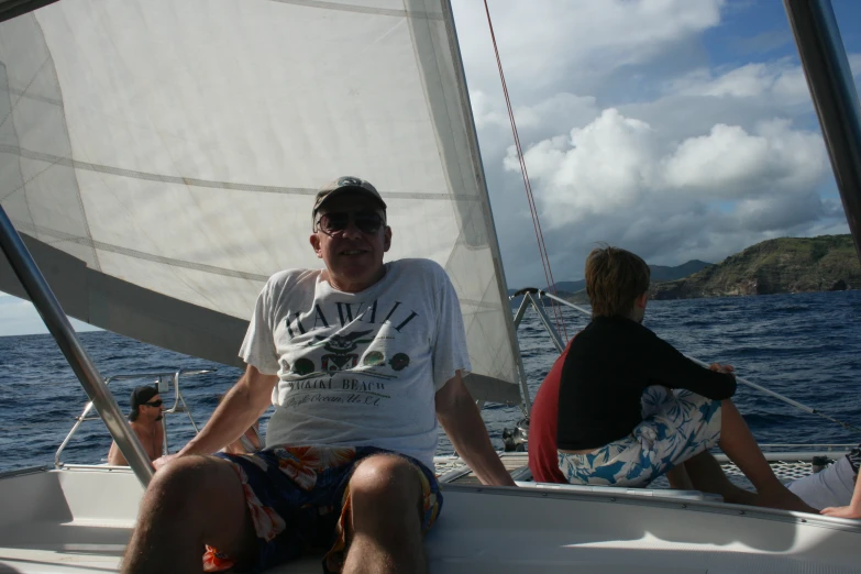 two people sitting on the bow of a boat