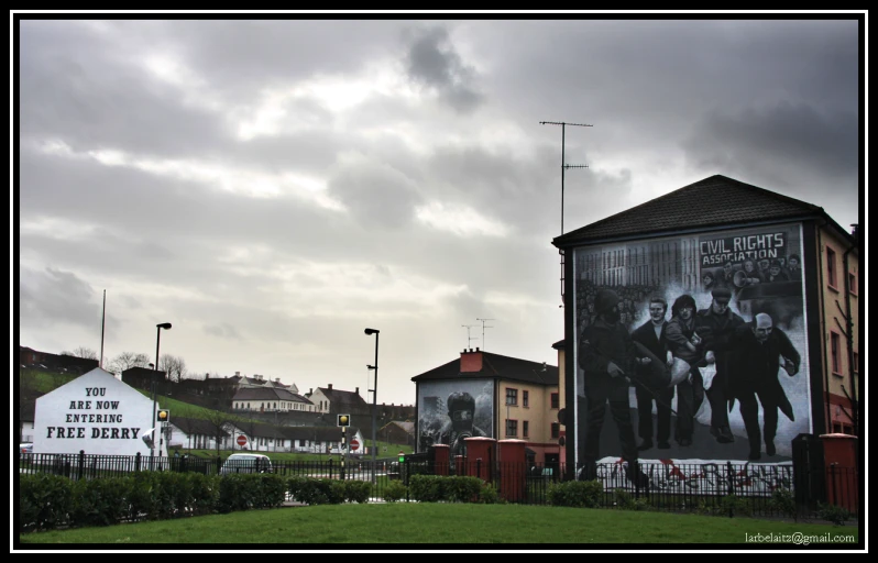 a building has a mural of several people on it