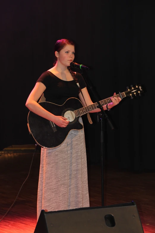 a person that is playing a guitar on stage