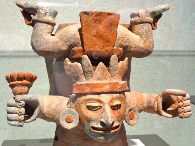 a statue with two arms in the air on display