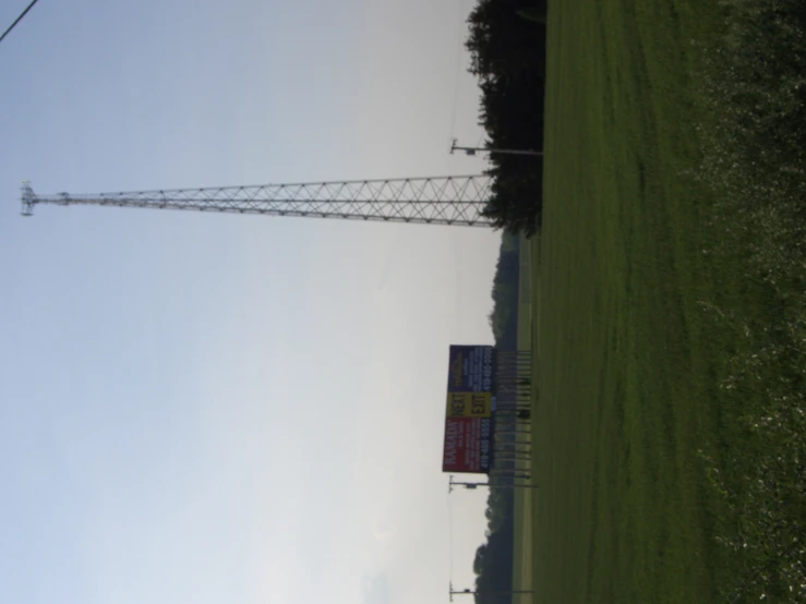 some telephone poles and signs in the grass