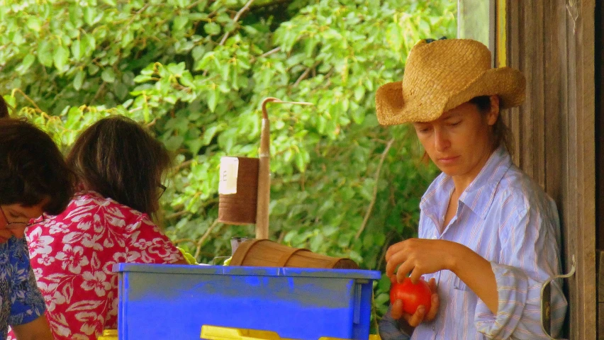 a person with a hat standing at a table