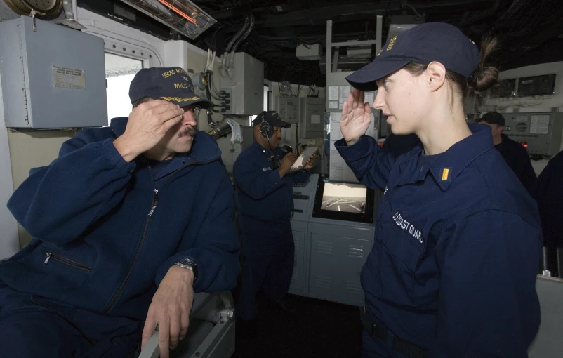 navy sailors look through the goggles on an aircraft