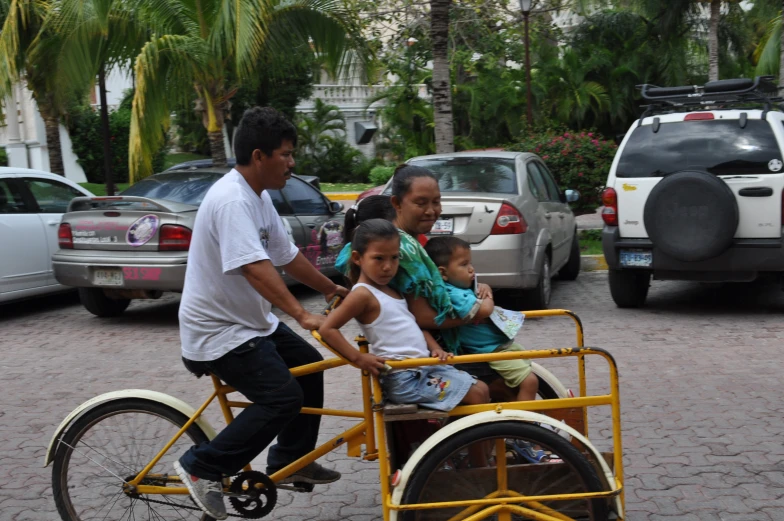 a man riding a rickshaw filled with small children