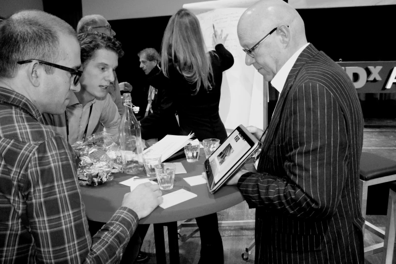 two men and a woman at an event at an exhibition