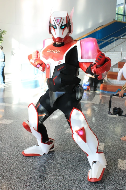 a boy in a robot suit carrying a pink object