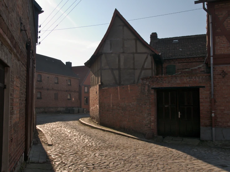 an old brick street surrounded by buildings