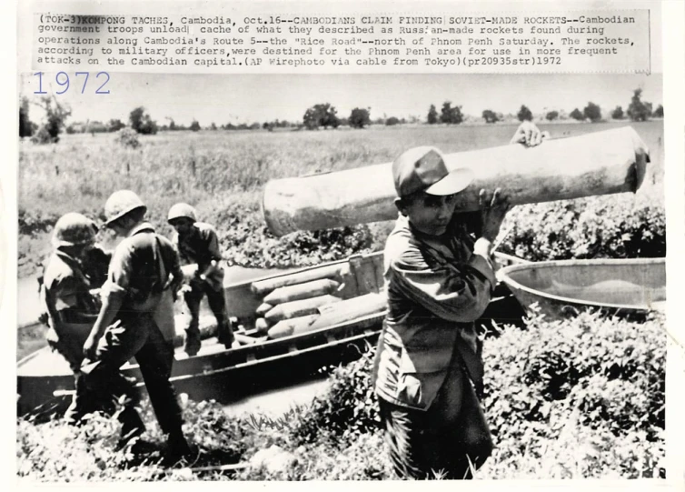 a man is carrying a big object down the field