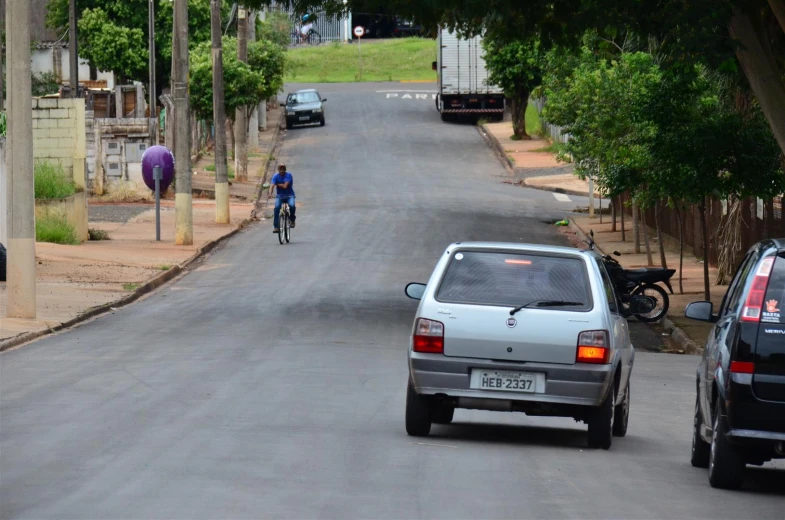 a man riding a bike down a rural street